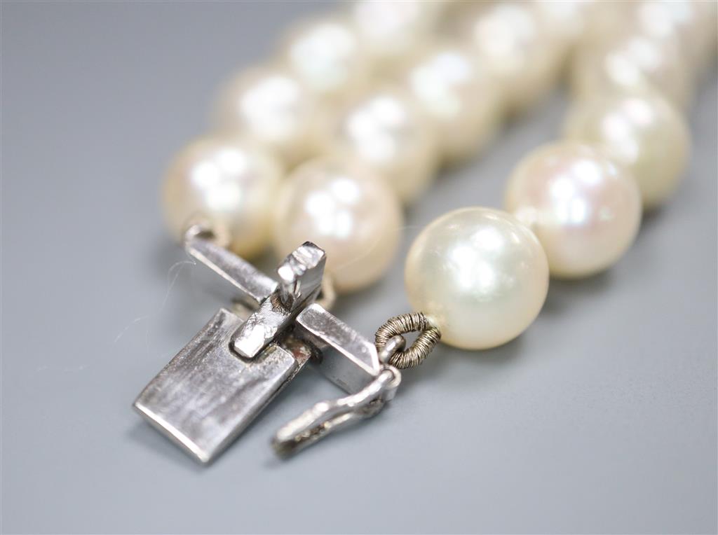A triple strand cultured pearl bracelet, with diamond set white metal clasp, 17.5cm, gross 38.7 grams,